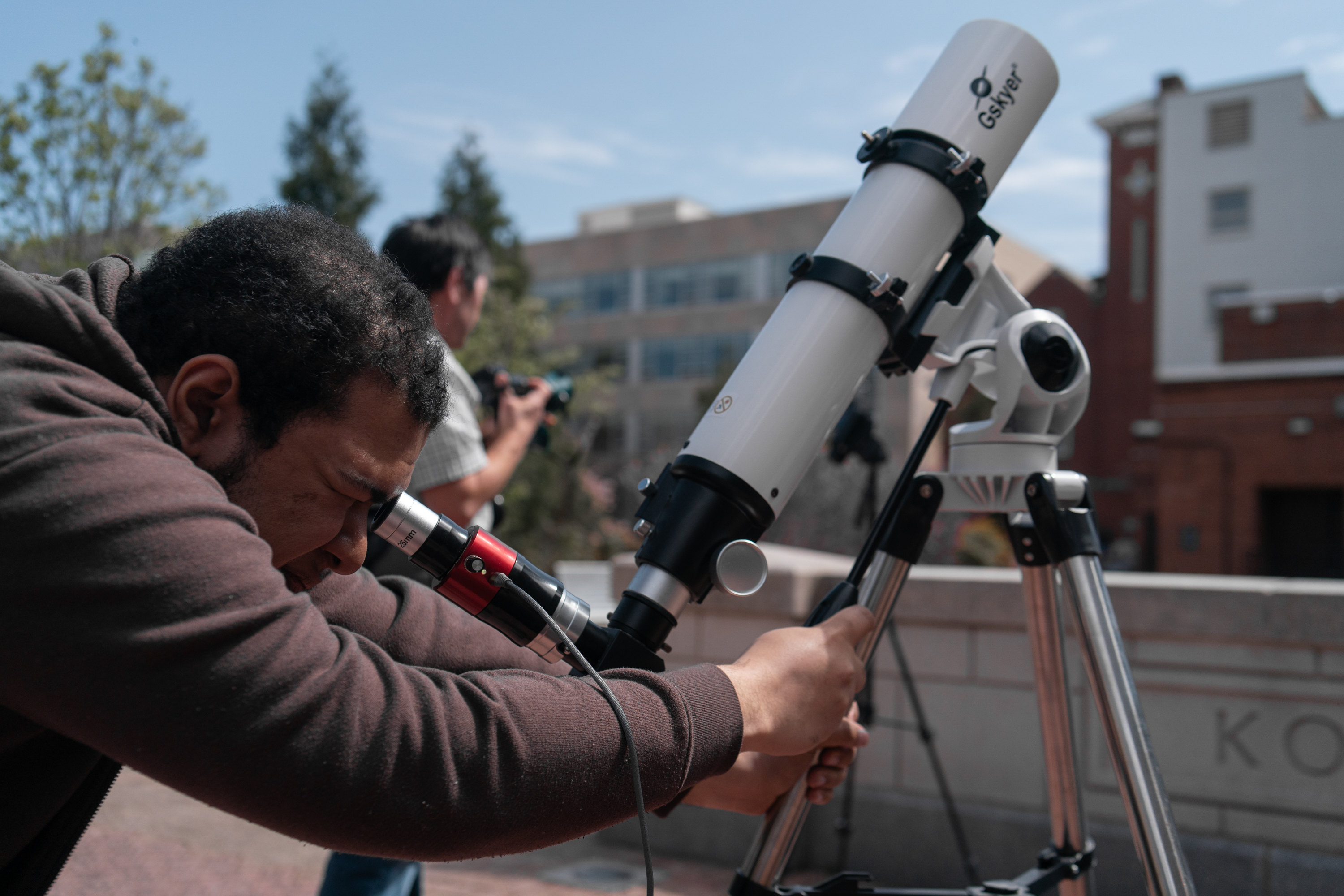 Student looking through a telescope
