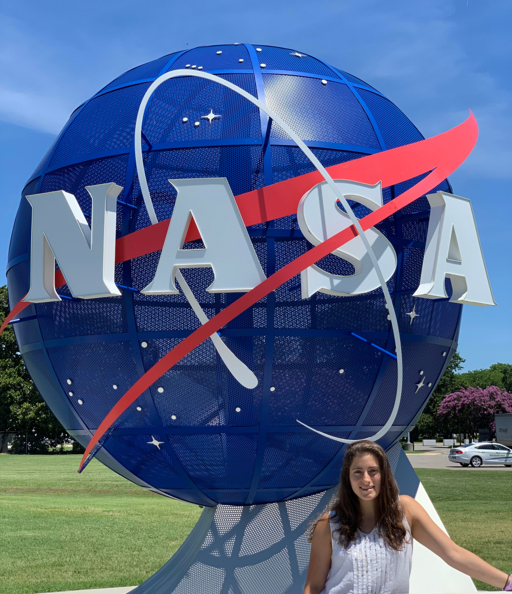 Vicky Nilsen posing in front of NASA globe